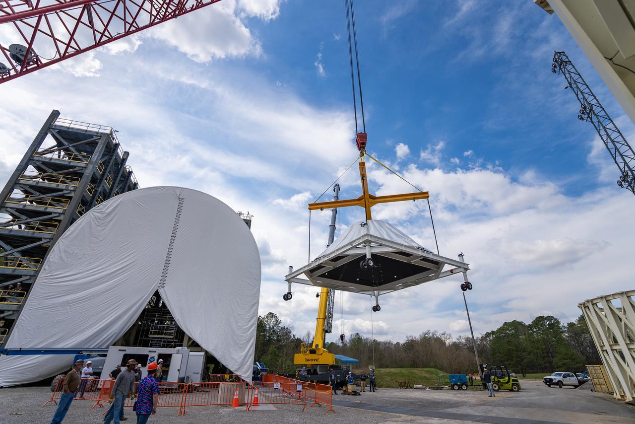 These photos and videos show how crews at NASA’s Marshall Space Flight Center in Huntsville, Alabama, moved and installed the payload adapter that will be used in the Block 1B configuration of the SLS (Space Launch System) rocket from Building 4708, where it was manufactured, into Structural Test Stand 4697 at NASA’s Marshall Space Flight Center on March 13. Teams at Marshall will begin structural testing the engineering development unit of the payload adapter – an exact replica of the flight version of the hardware – this spring. The cone-shaped payload adapter is about 8.5 feet tall and features two metal rings and eight composite panels. The adapter, which will debut on NASA’s Artemis IV mission, is an evolution from the Orion stage adapter used in the Block 1 configuration of the first three Artemis missions. It will be housed inside the universal stage adapter atop the rocket’s more powerful in-space stage, called the exploration upper stage. The payload adapter, like the launch vehicle stage adapter and the Orion stage adapter, is fully manufactured and tested at Marshall, which manages the SLS Program. NASA is working to land the first woman, first person of color, and its first international partner astronaut on the Moon under Artemis. SLS is part of NASA’s backbone for deep space exploration, along with the Orion spacecraft and Gateway in orbit around the Moon and commercial human landing systems, next-generational spacesuits, and rovers on the lunar surface. SLS is the only rocket that can send Orion, astronauts, and supplies to the Moon in a single launch.